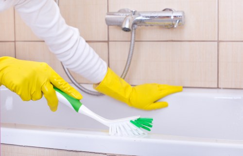 Technician performing carpet cleaning in a home