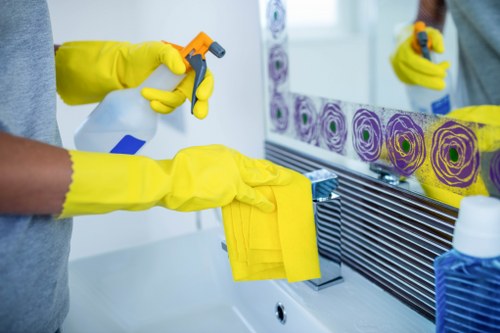 Commercial cleaning team sanitizing high-touch surfaces in a workplace