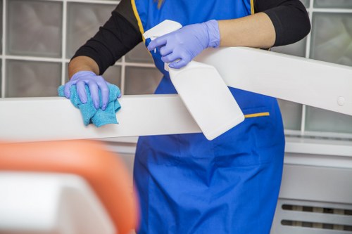 Office cleaning staff sanitizing shared work surfaces